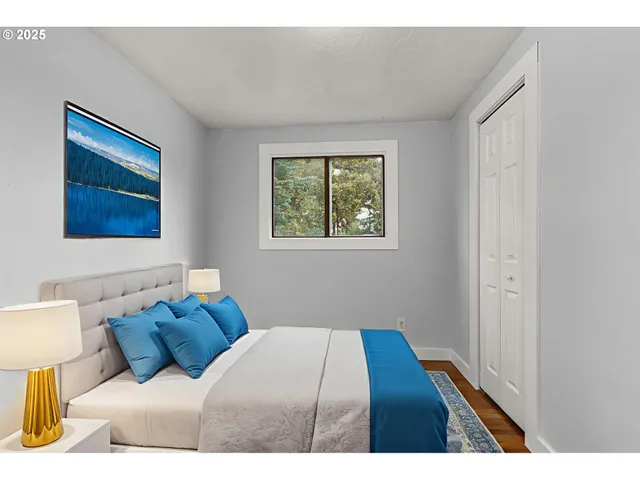 a bedroom with a bed and a night stand