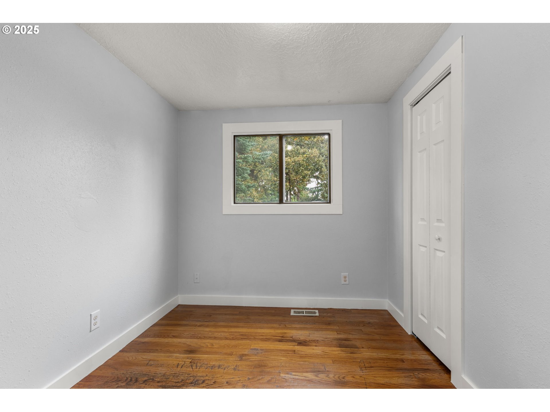 1203 Northeast 190th Place Portland, OR 97230 - Photo 32 of 48 a view of an empty room with wooden floor and a window