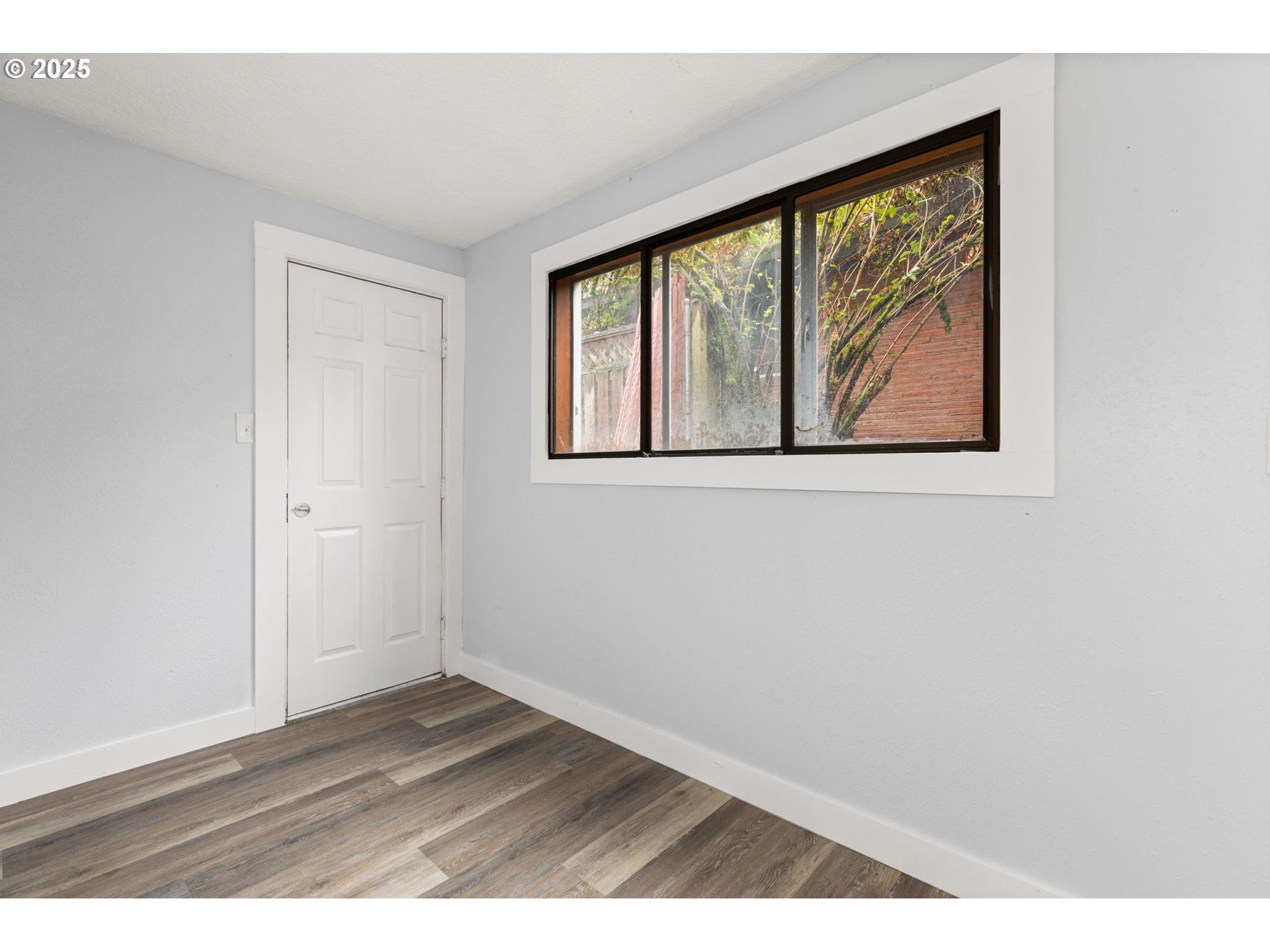 1203 Northeast 190th Place Portland, OR 97230 - Photo 38 of 48 a view of an empty room with wooden floor and a window