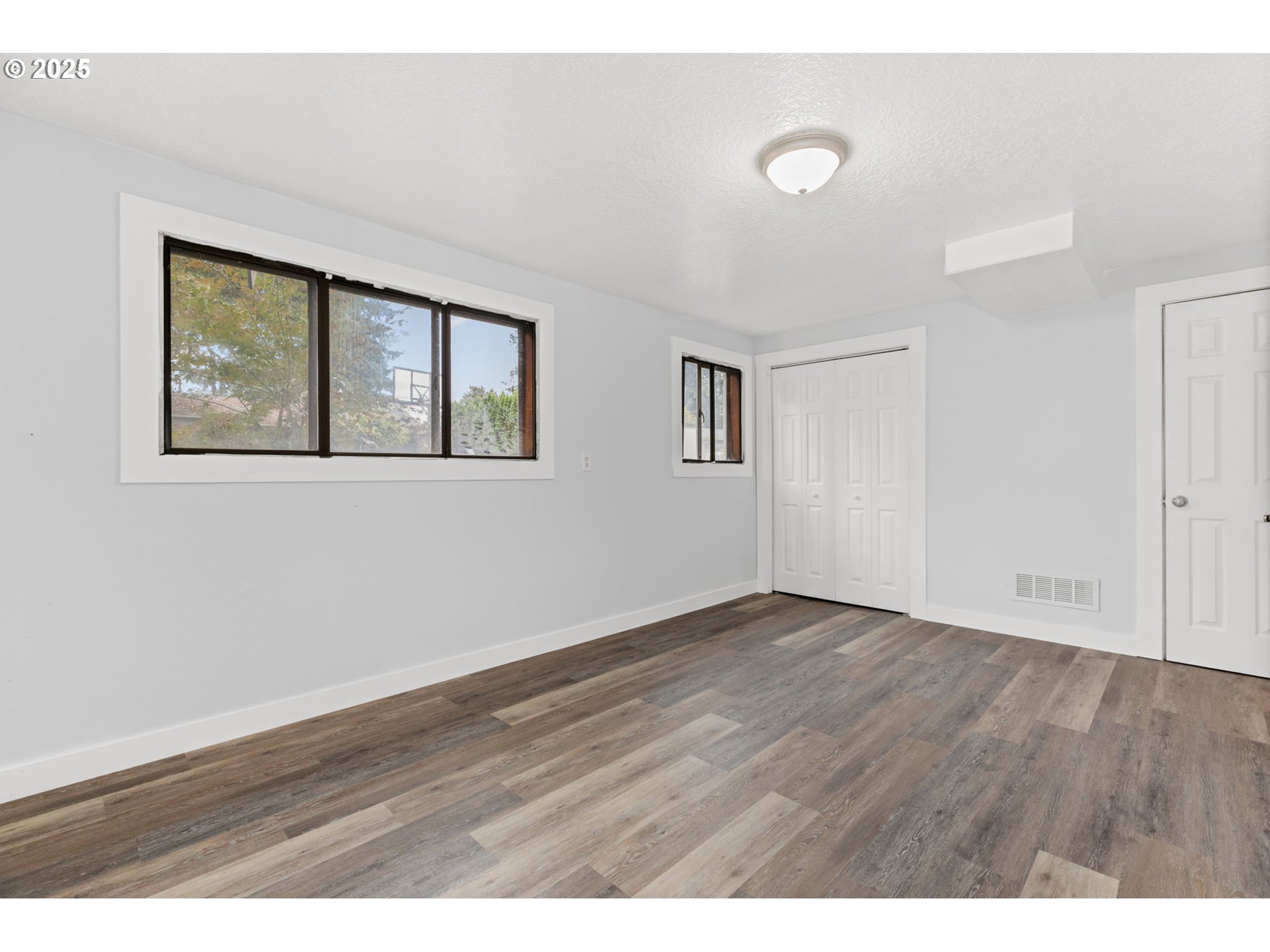 1203 Northeast 190th Place Portland, OR 97230 - Photo 41 of 48 a view of an empty room with wooden floor and a window