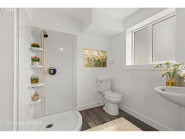 a bathroom with a toilet a sink a shower and vanity