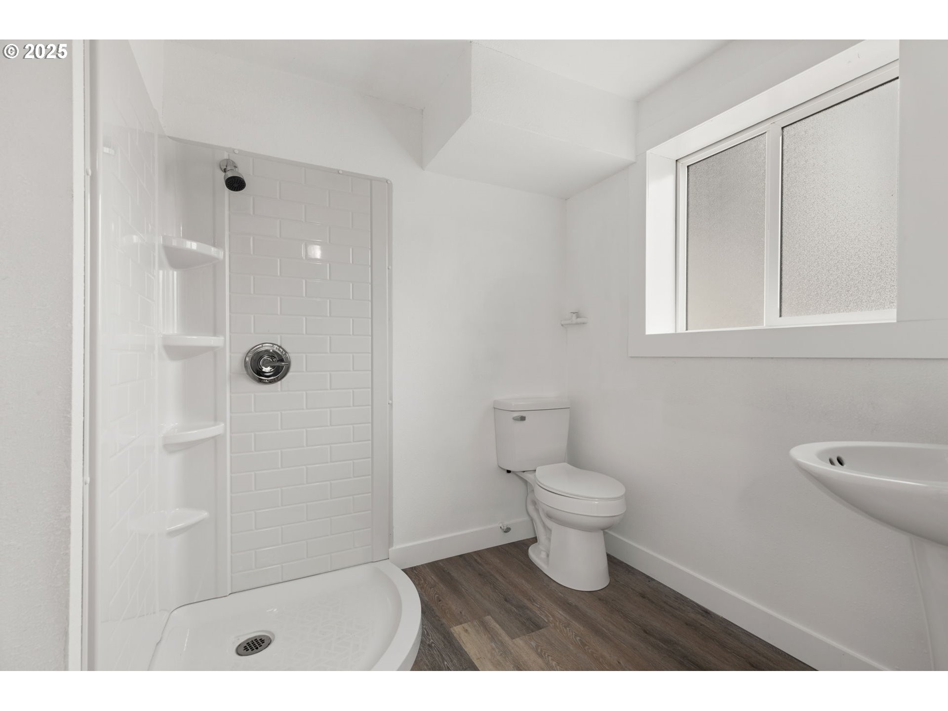 1203 Northeast 190th Place Portland, OR 97230 - Photo 43 of 48 a bathroom with a toilet a sink a shower and a window