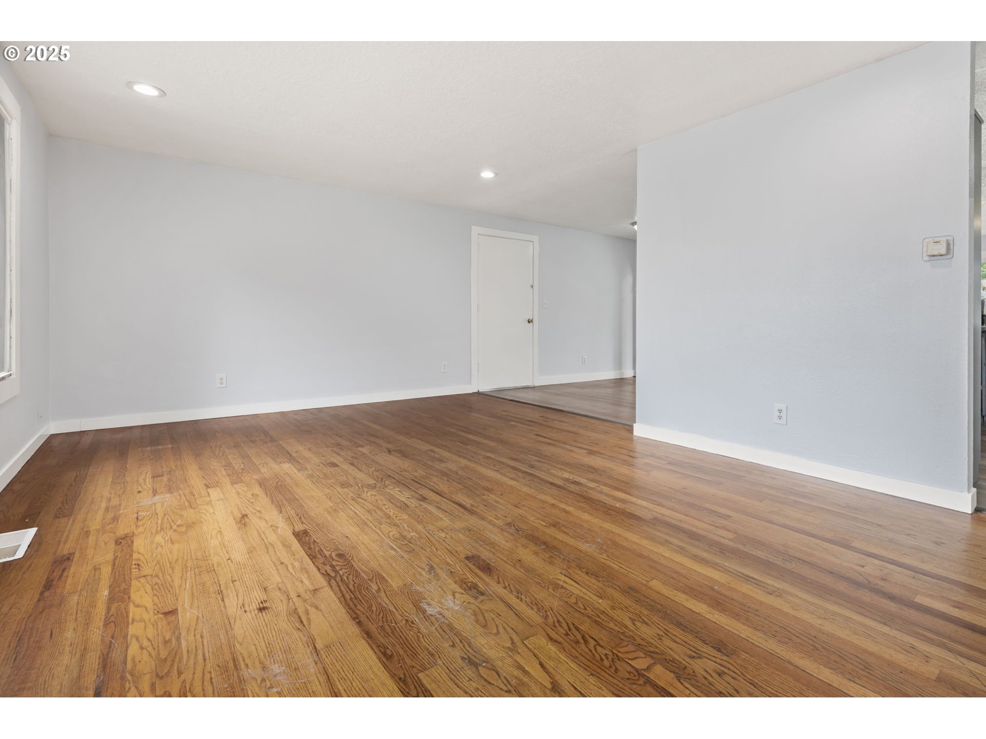 1203 Northeast 190th Place Portland, OR 97230 - Photo 6 of 48 a view of an empty room and wooden floor