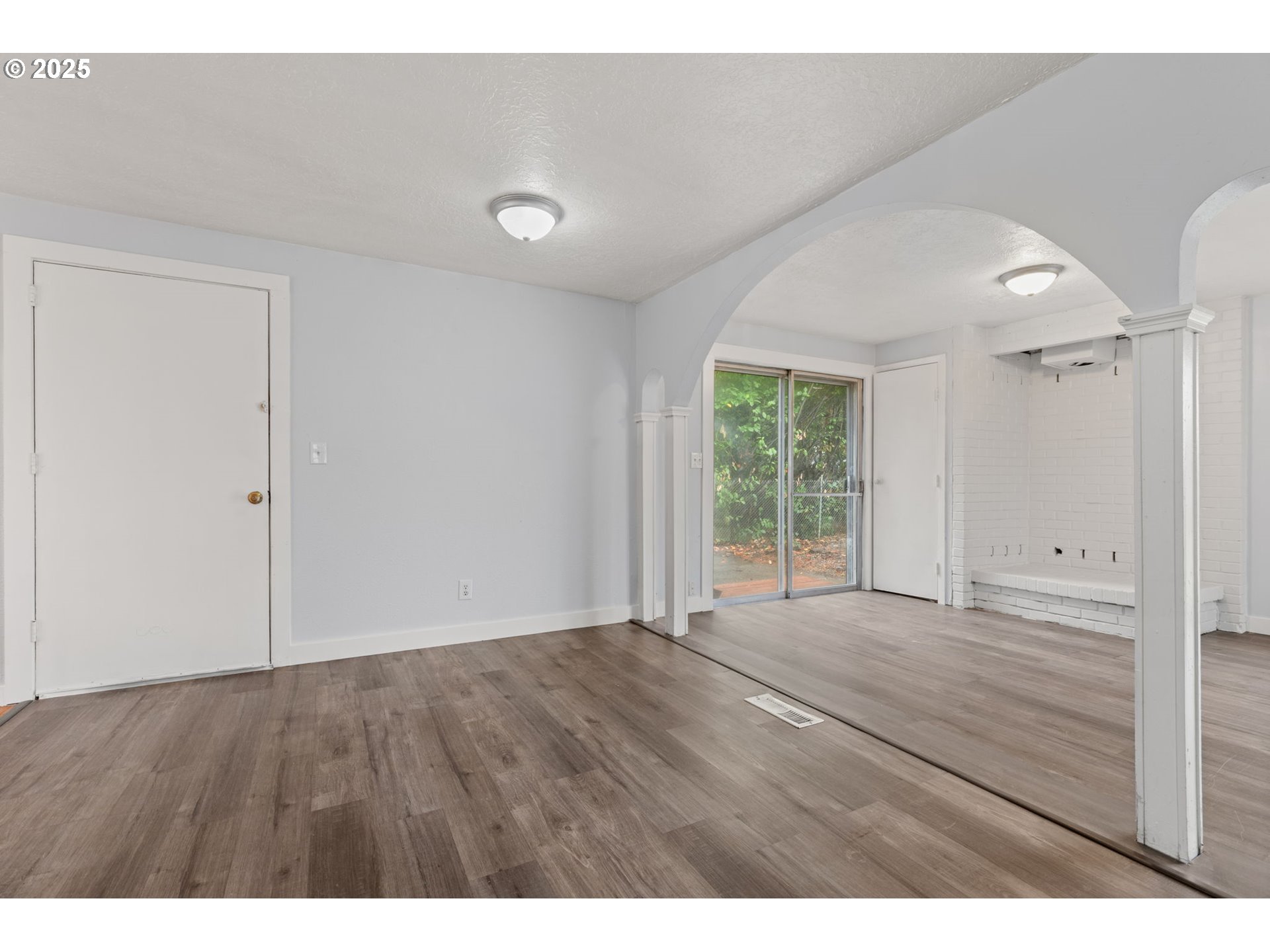 1203 Northeast 190th Place Portland, OR 97230 - Photo 10 of 48 a view of an empty room with wooden floor and a window