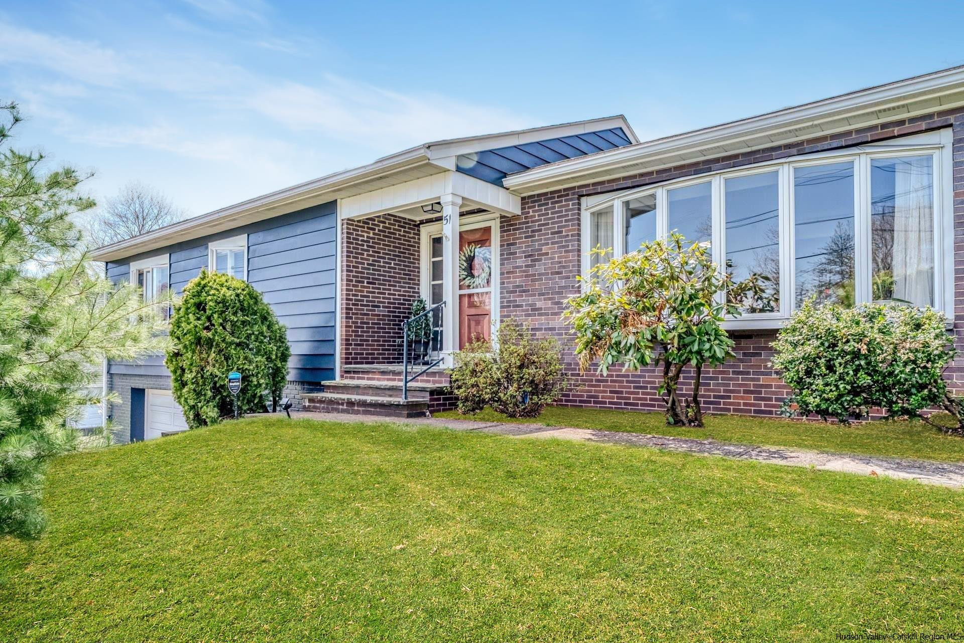 a view of a house with a yard and plants
