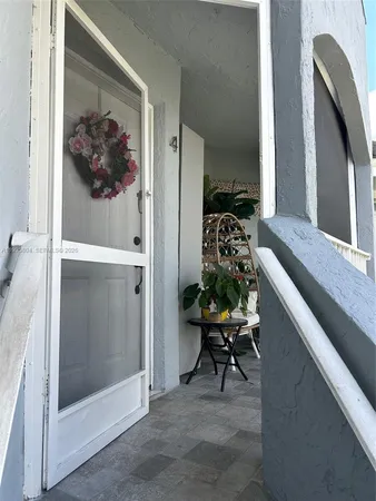 a view of a hallway and a dining room with furniture