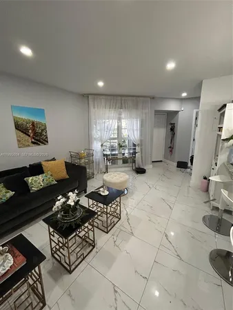 a view of living room with couch and chairs