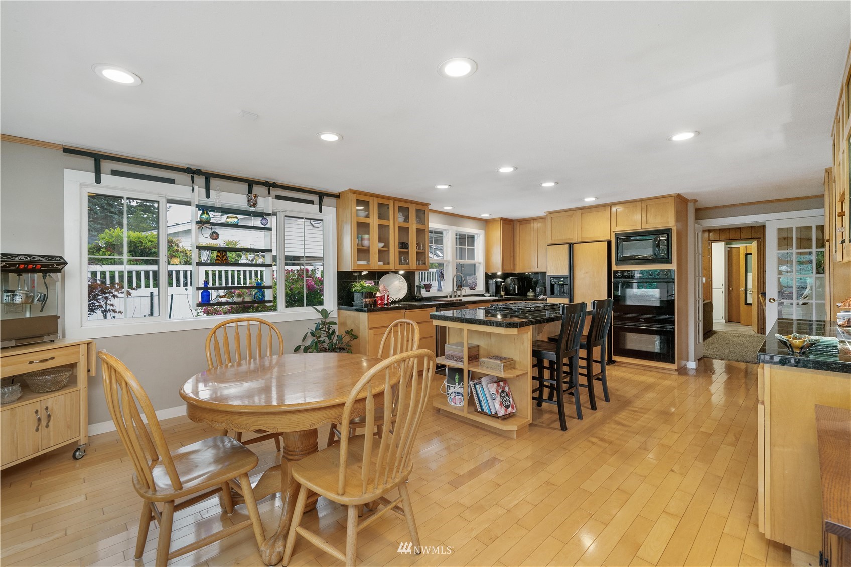 9215 Lake Steilacoom Point Road Southwest Lakewood, WA 98498 - Photo 14 of 36 a dining area with stainless steel appliances kitchen island granite countertop a dining table chairs and view living room