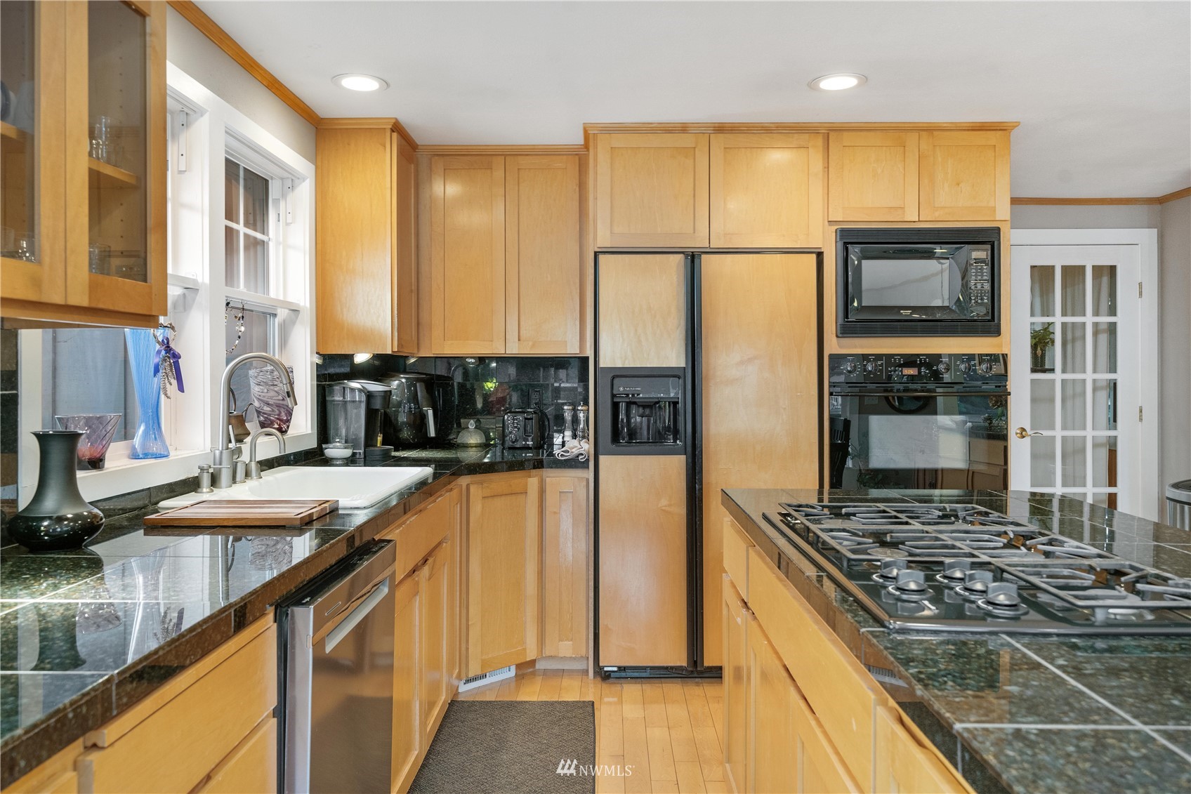 9215 Lake Steilacoom Point Road Southwest Lakewood, WA 98498 - Photo 19 of 36 a kitchen with stainless steel appliances granite countertop a stove and a refrigerator