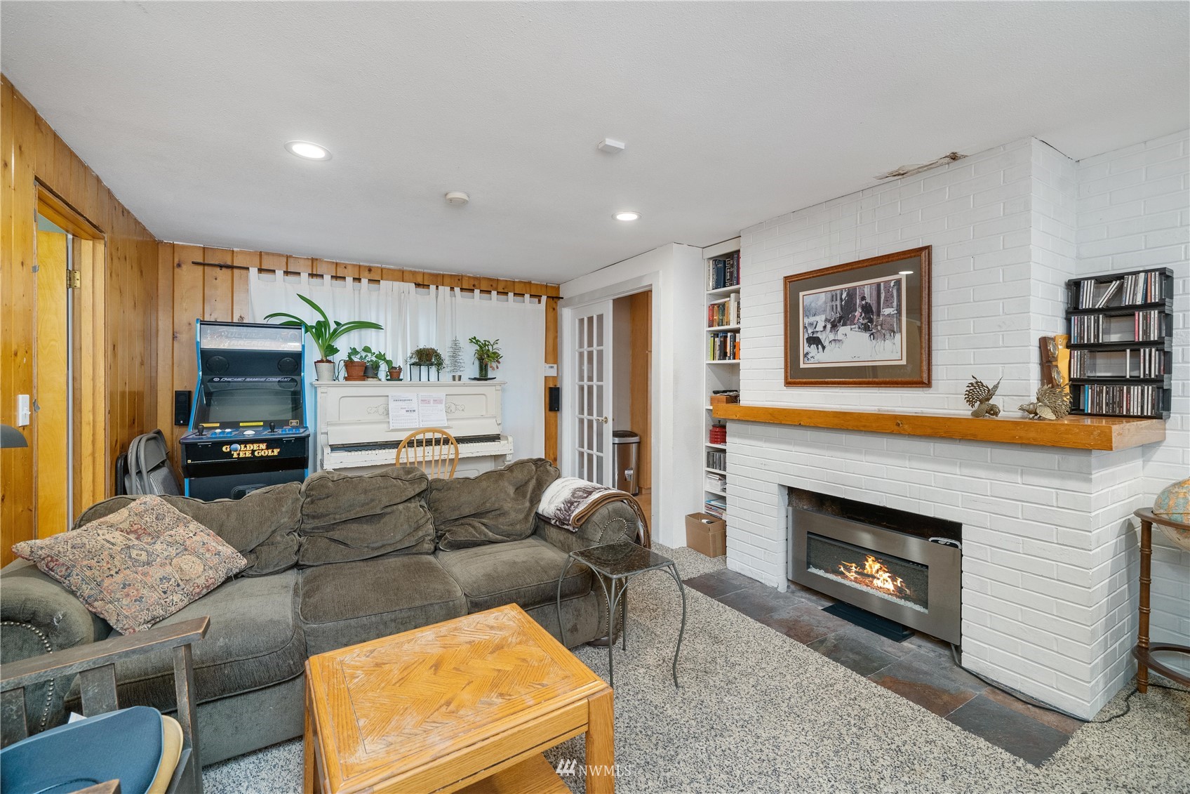 9215 Lake Steilacoom Point Road Southwest Lakewood, WA 98498 - Photo 22 of 36 a living room with furniture and a fireplace