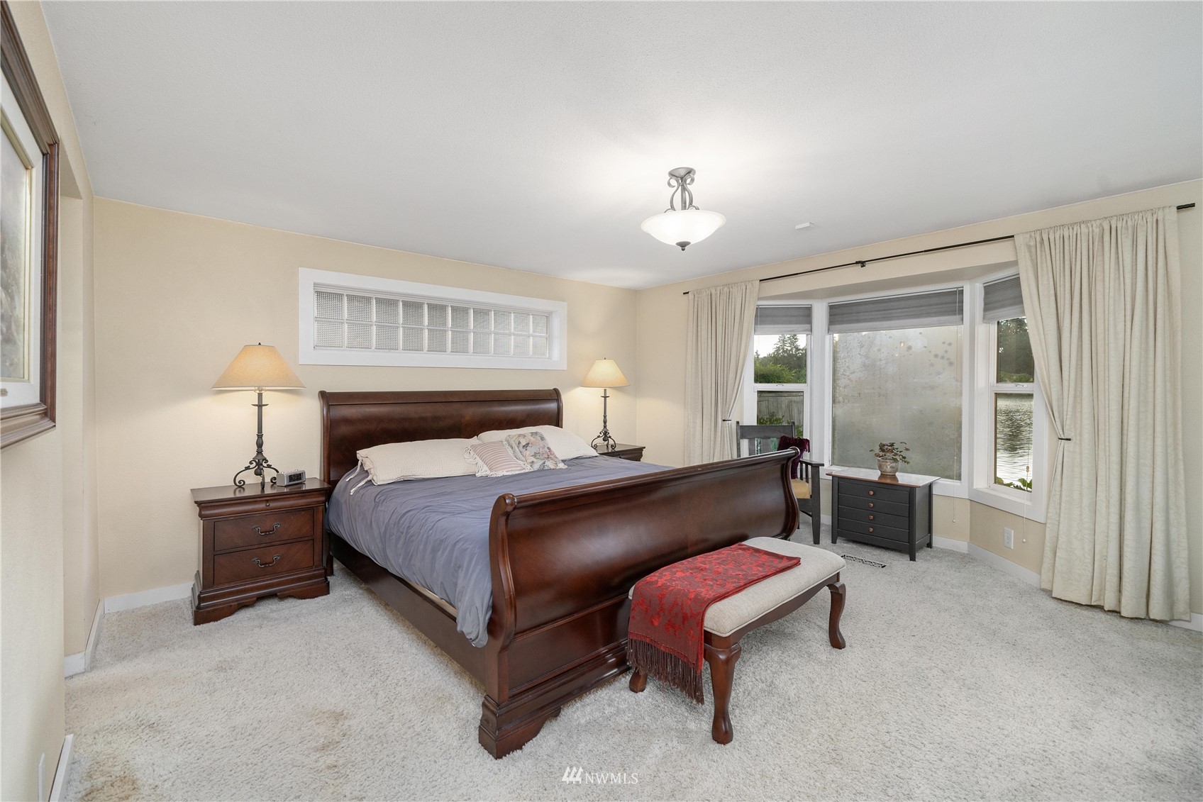9215 Lake Steilacoom Point Road Southwest Lakewood, WA 98498 - Photo 25 of 36 a spacious bedroom with a bed and window