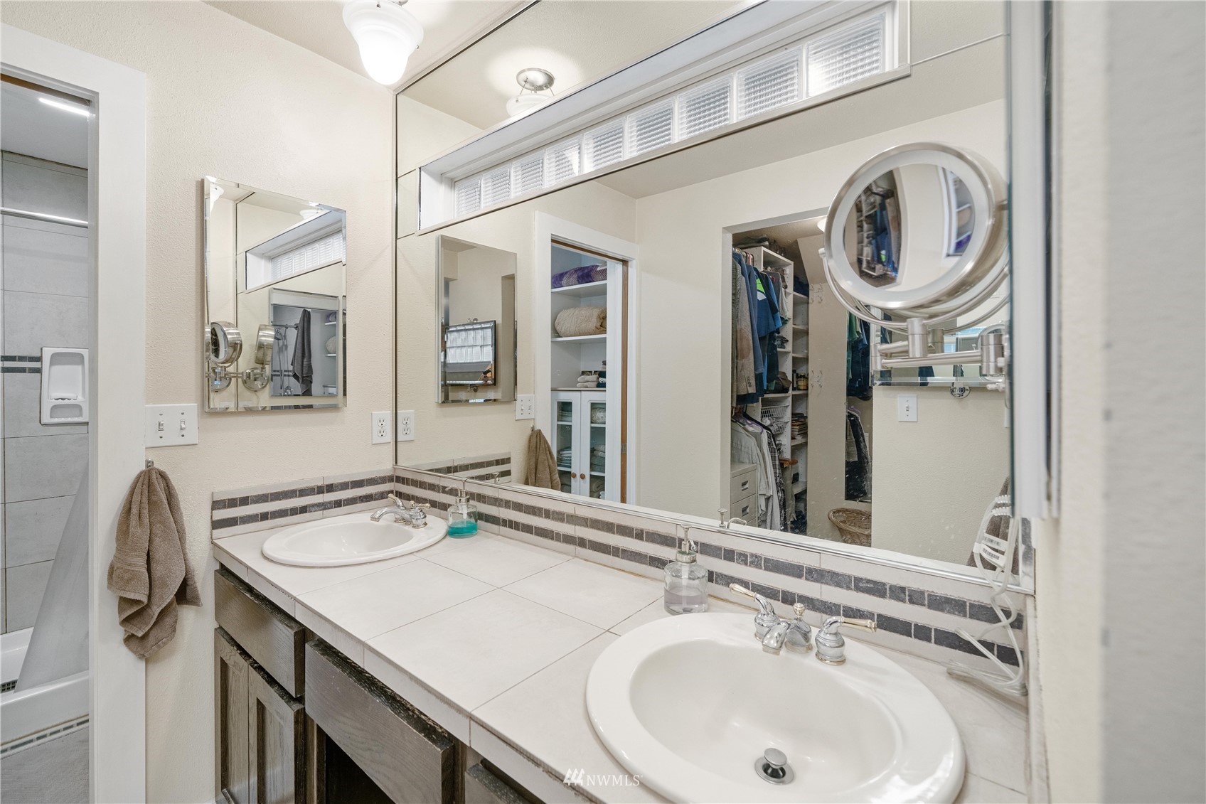 9215 Lake Steilacoom Point Road Southwest Lakewood, WA 98498 - Photo 27 of 36 a bathroom with a sink and a mirror