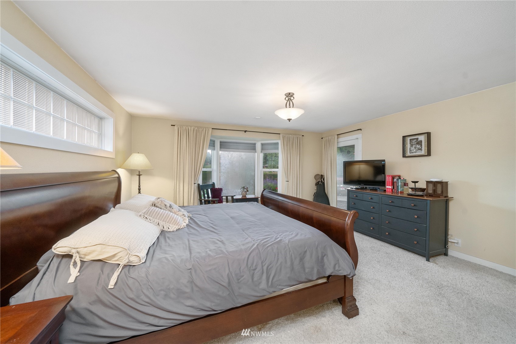 9215 Lake Steilacoom Point Road Southwest Lakewood, WA 98498 - Photo 31 of 36 a bedroom with a bed and a flat screen tv