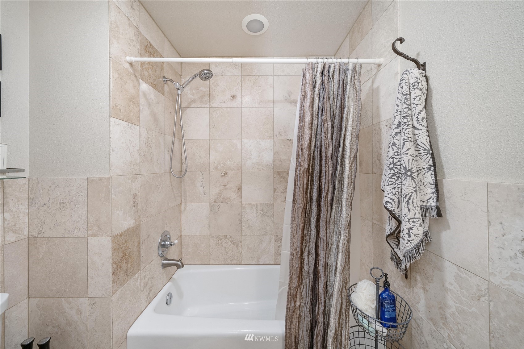 9215 Lake Steilacoom Point Road Southwest Lakewood, WA 98498 - Photo 33 of 36 a bathroom with a shower curtain and a bathtub