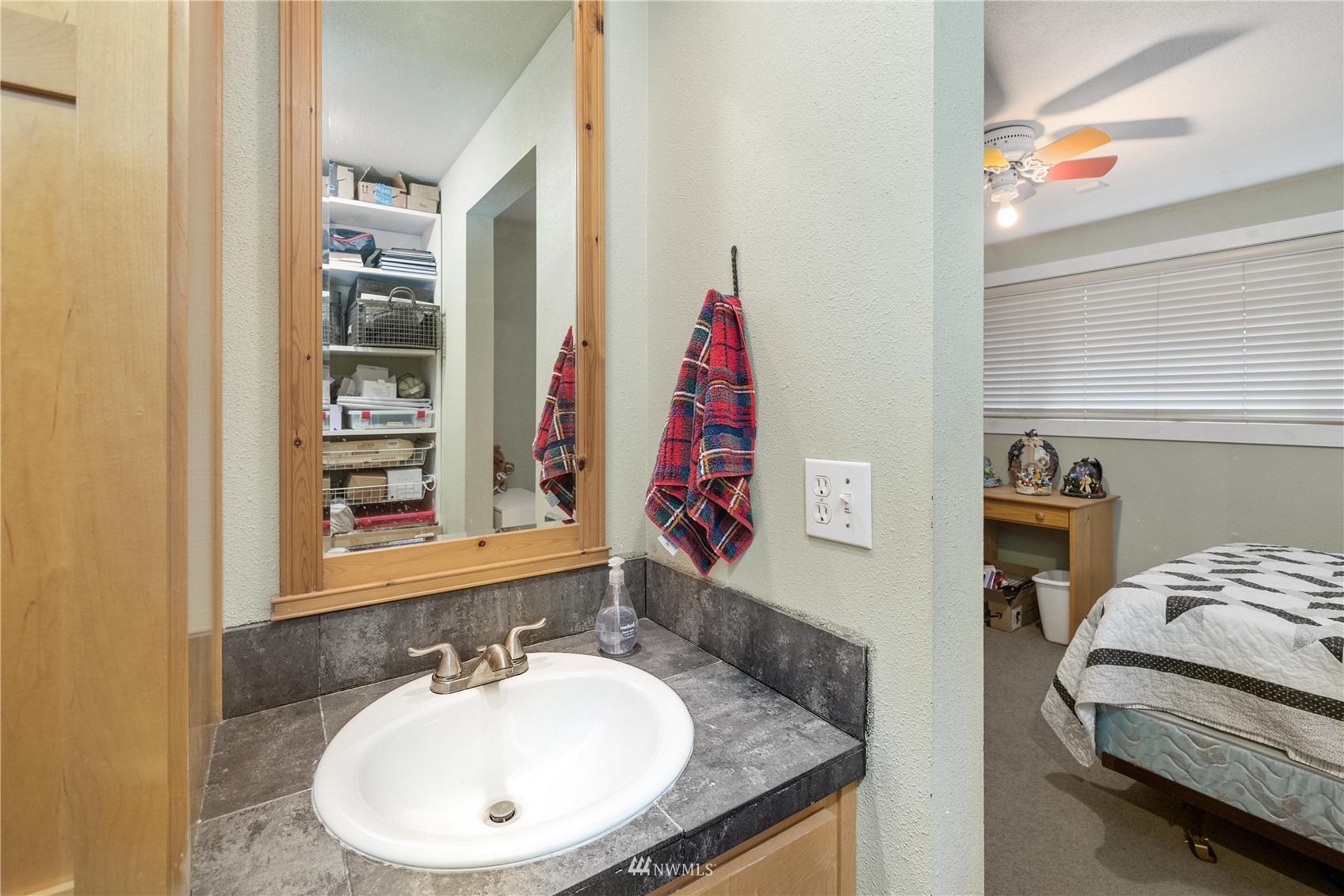 9215 Lake Steilacoom Point Road Southwest Lakewood, WA 98498 - Photo 36 of 36 a bathroom with a sink and a mirror