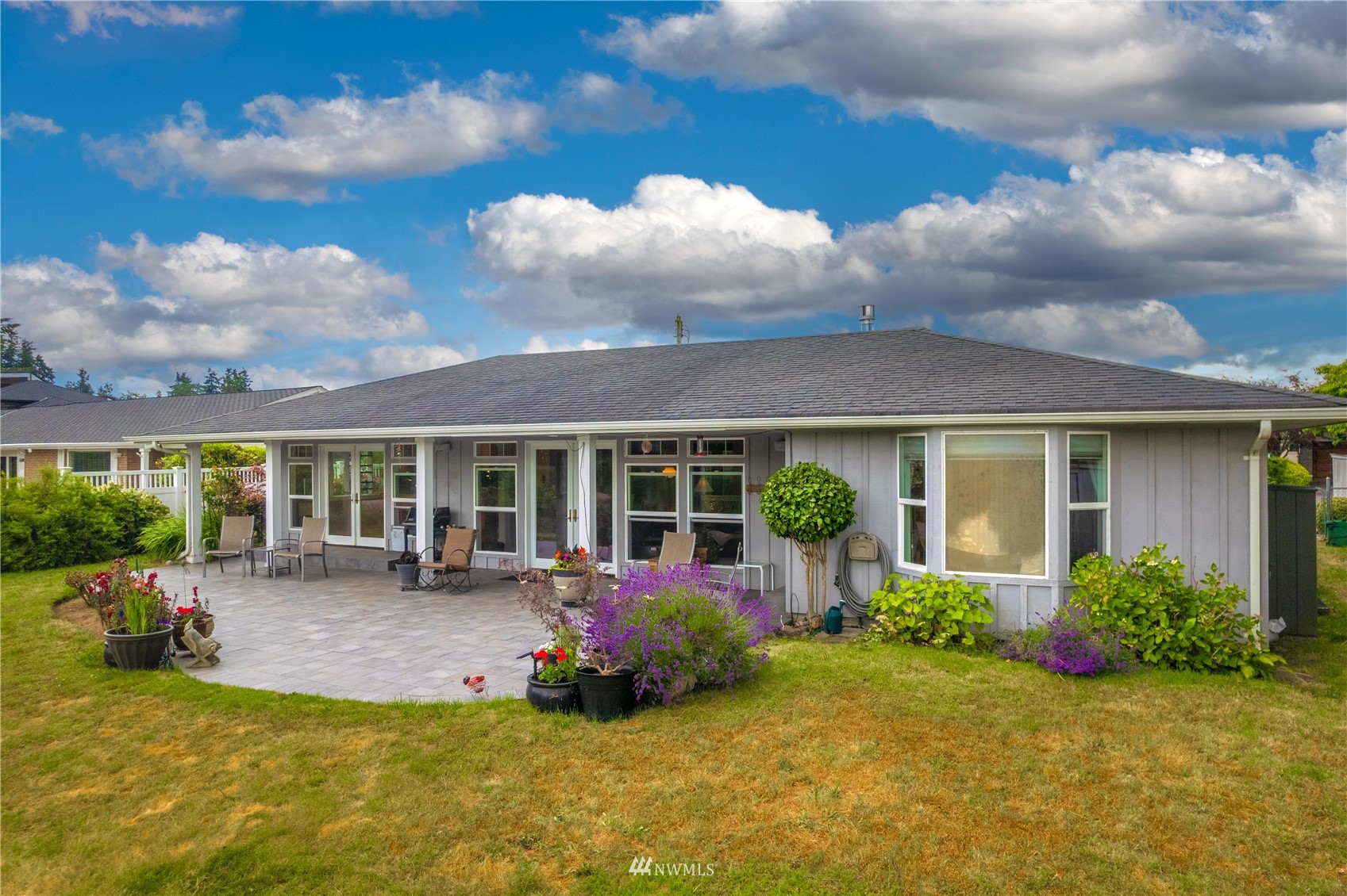 9215 Lake Steilacoom Point Road Southwest Lakewood, WA 98498 - Photo 7 of 36 a view of a house with backyard sitting area and garden