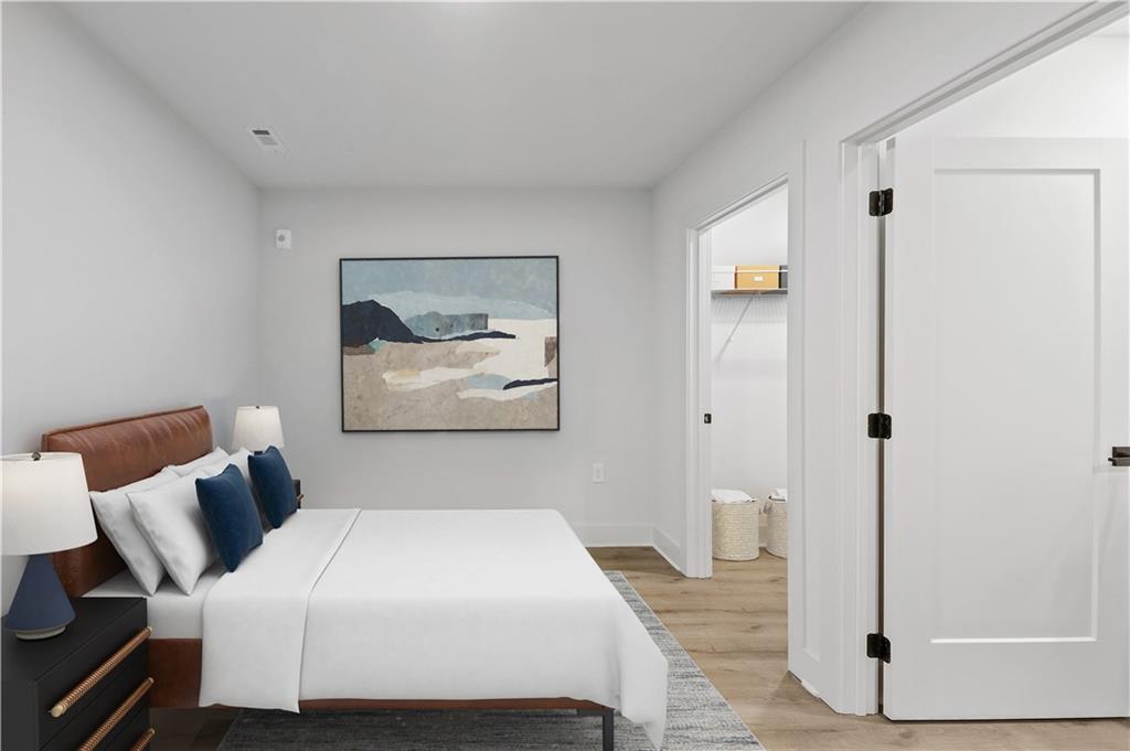 a bedroom with a bed and painting on the wall