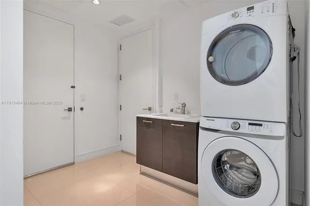 a utility room with sink dryer and washer