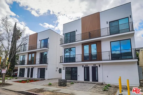 a front view of a building with parking space