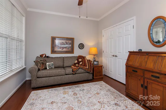 a living room with furniture a mirror and a window
