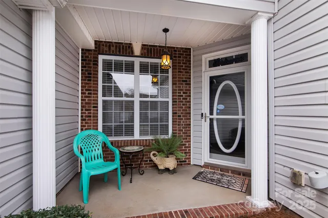 a view of a door and chair in the balcony