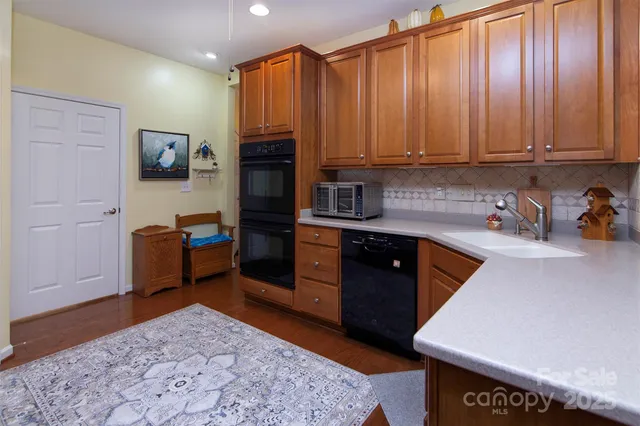 a kitchen with stainless steel appliances granite countertop a sink stove and cabinets