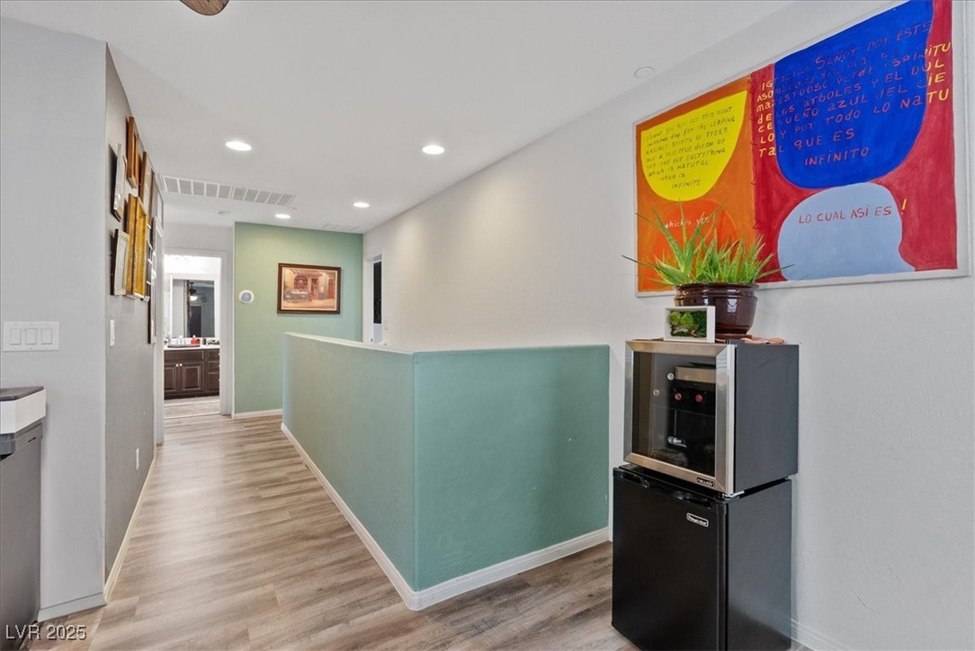 9040 Magnetic Court Las Vegas, NV 89149 - Photo 15 of 43 Hallway featuring wood finished floors, recessed lighting, and an upstairs landing