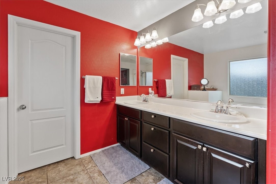 9040 Magnetic Court Las Vegas, NV 89149 - Photo 19 of 43 Full bath with double vanity and light tile patterned floors