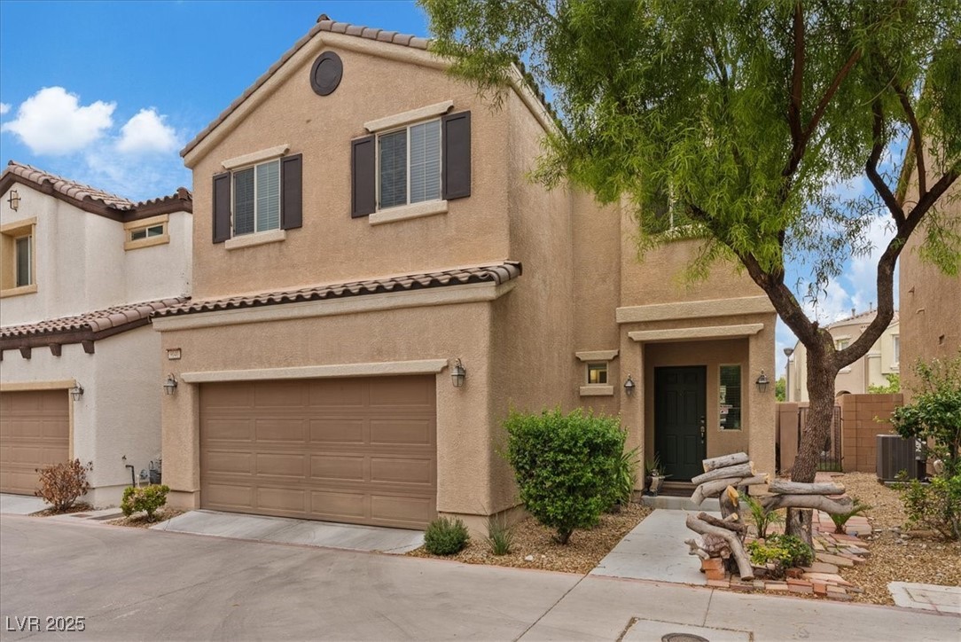 9040 Magnetic Court Las Vegas, NV 89149 - Photo 2 of 43 Mediterranean / spanish-style house with stucco siding, a tiled roof, an attached garage, and concrete driveway