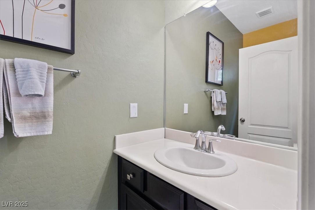 9040 Magnetic Court Las Vegas, NV 89149 - Photo 23 of 43 Bathroom with a textured wall and vanity