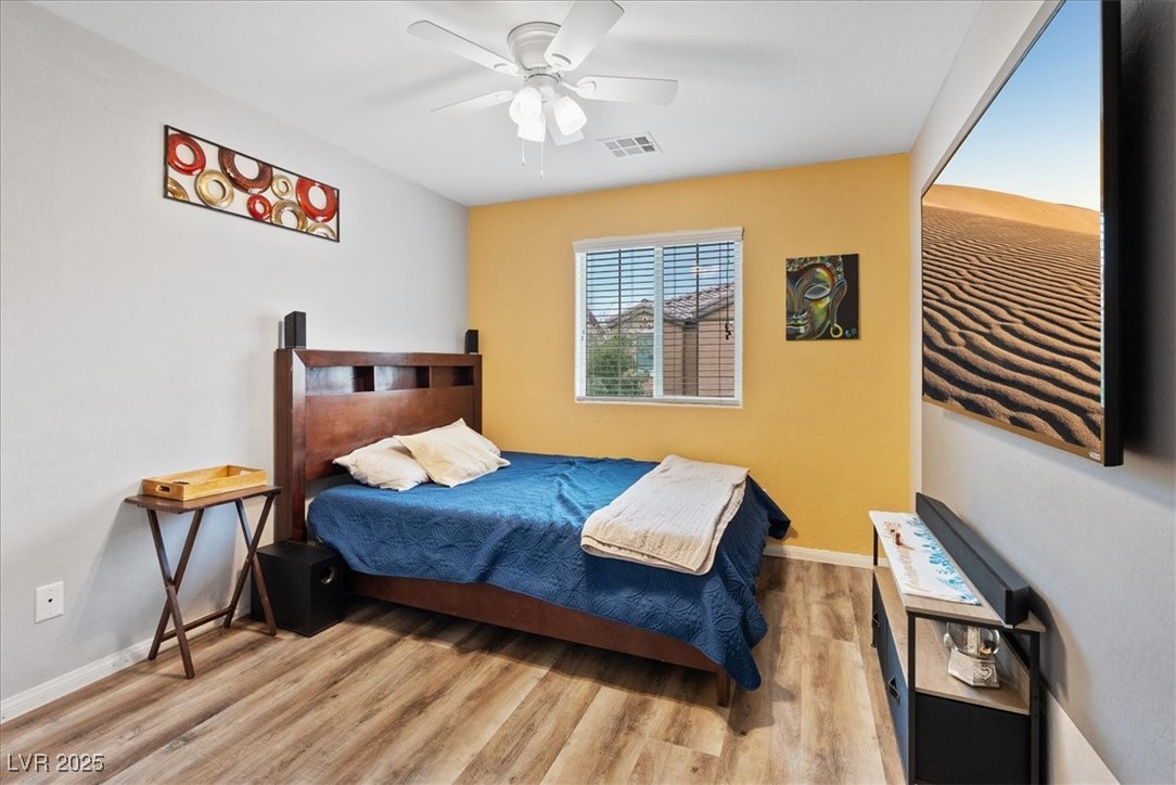 9040 Magnetic Court Las Vegas, NV 89149 - Photo 24 of 43 Bedroom with wood finished floors and a ceiling fan