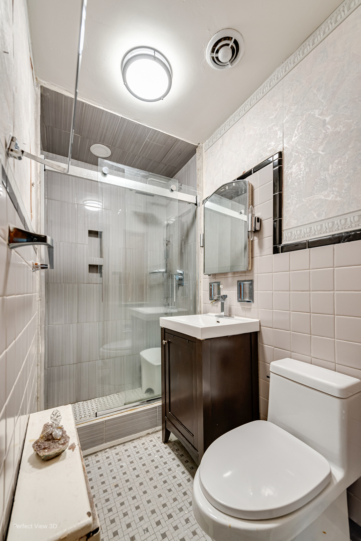 6726 South Merrill Avenue Chicago, IL 60649 - Photo 16 of 22 a bathroom with a sink a toilet and shower