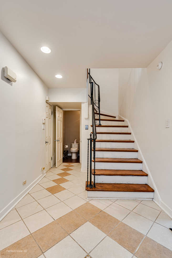 6726 South Merrill Avenue Chicago, IL 60649 - Photo 2 of 22 a view of a livingroom with stairs and a floor to ceiling window