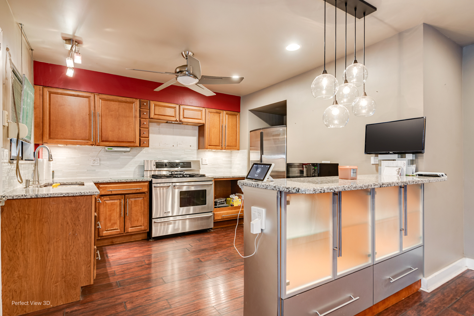 6726 South Merrill Avenue Chicago, IL 60649 - Photo 8 of 22 a kitchen with stainless steel appliances granite countertop a stove top oven a sink dishwasher and a microwave with wooden floor