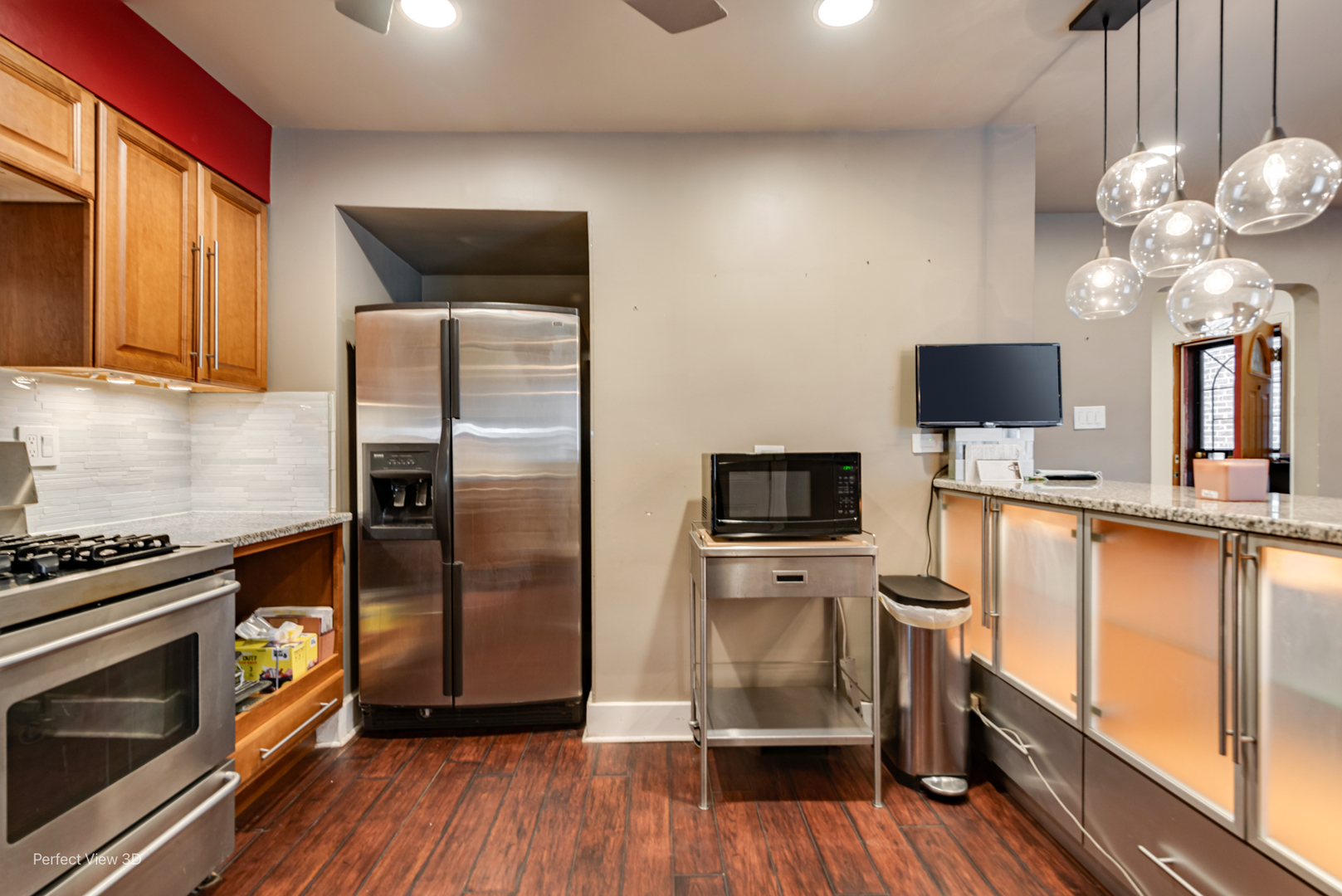 6726 South Merrill Avenue Chicago, IL 60649 - Photo 10 of 22 a kitchen with stainless steel appliances a stove microwave and a refrigerator