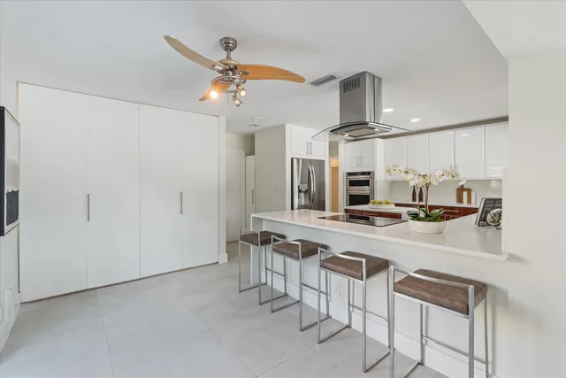 a kitchen with stainless steel appliances a sink and a refrigerator