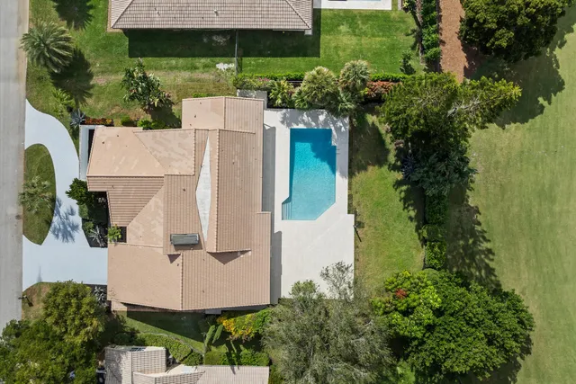 an aerial view of residential houses with outdoor space and lake view