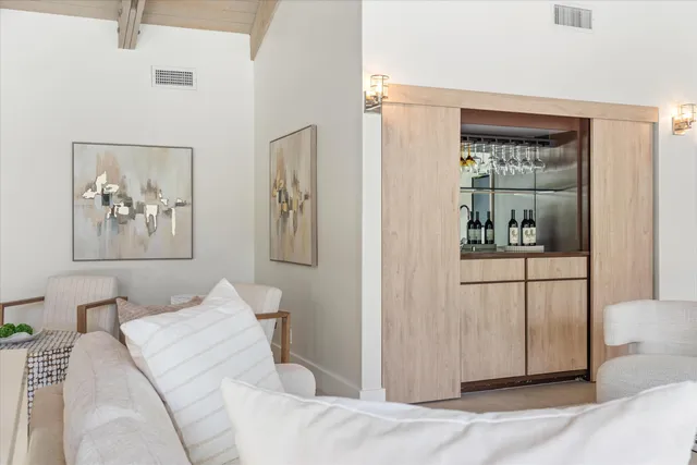 a bedroom with a bed and glass walk in closet