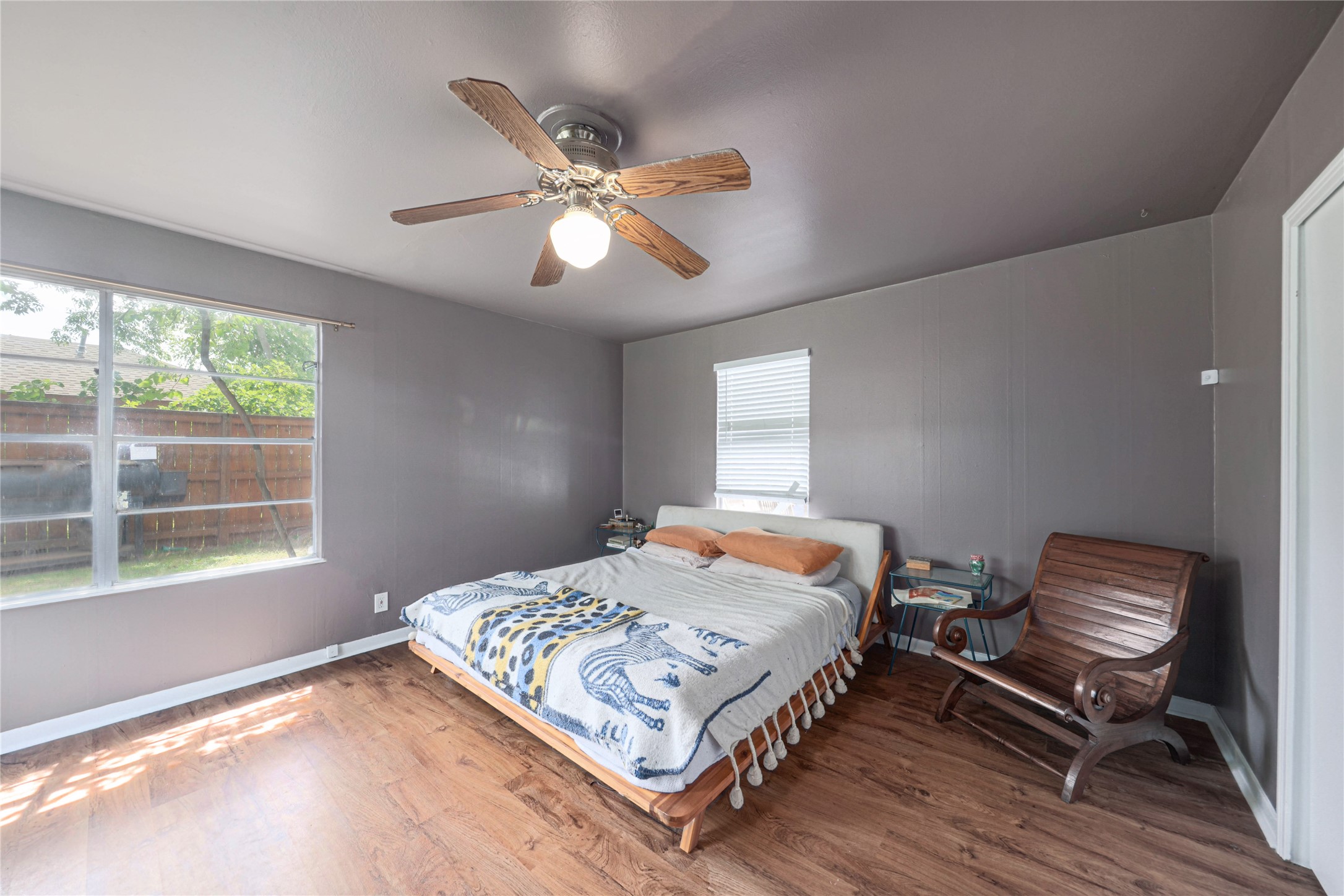 4607 Evans Avenue, Unit B Austin, TX 78751 - Photo 11 of 34 Bedroom featuring wood-finish flooring, a ceiling fan with integrated lighting, and painted gray walls