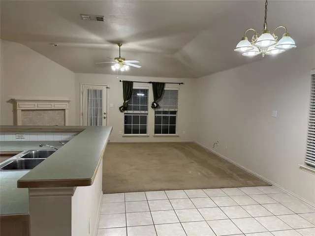 a view of a livingroom with a chandelier furniture and windows