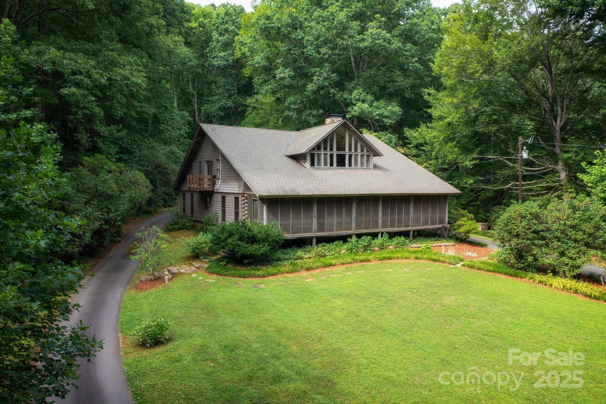 a house with a big yard plants and large trees