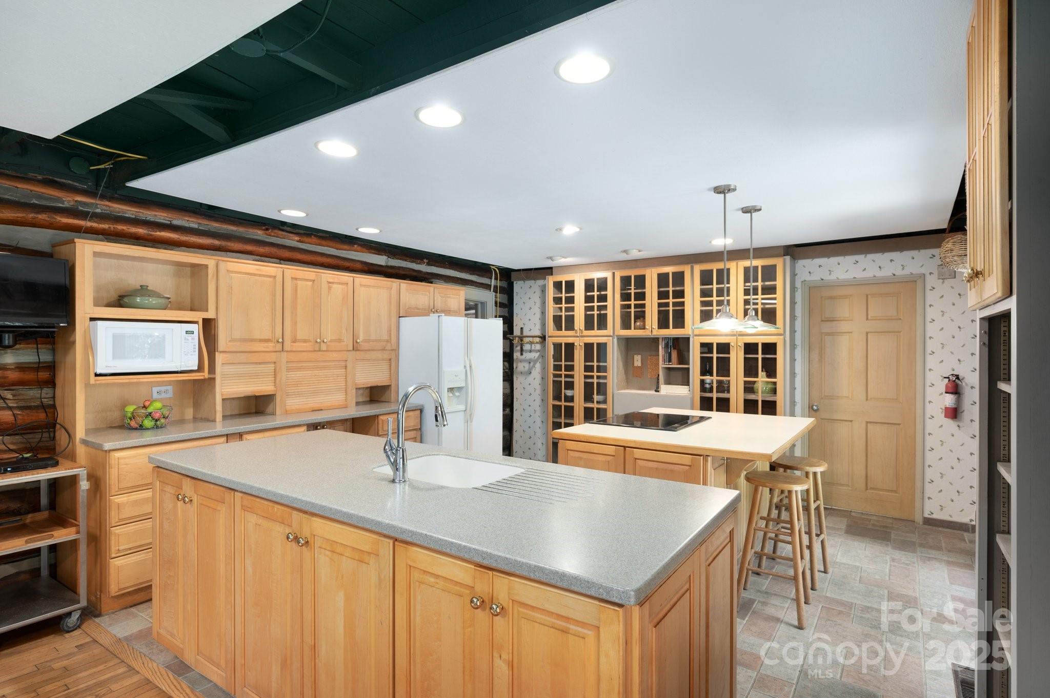 552 Averys Crk Road Arden, NC 28704 - Photo 15 of 48 a kitchen with stainless steel appliances granite countertop a sink and a large window