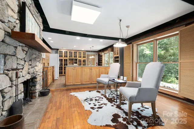 a dining room with furniture window and wooden floor