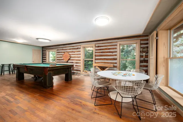 a living room with a bed couch and a large window with outer view
