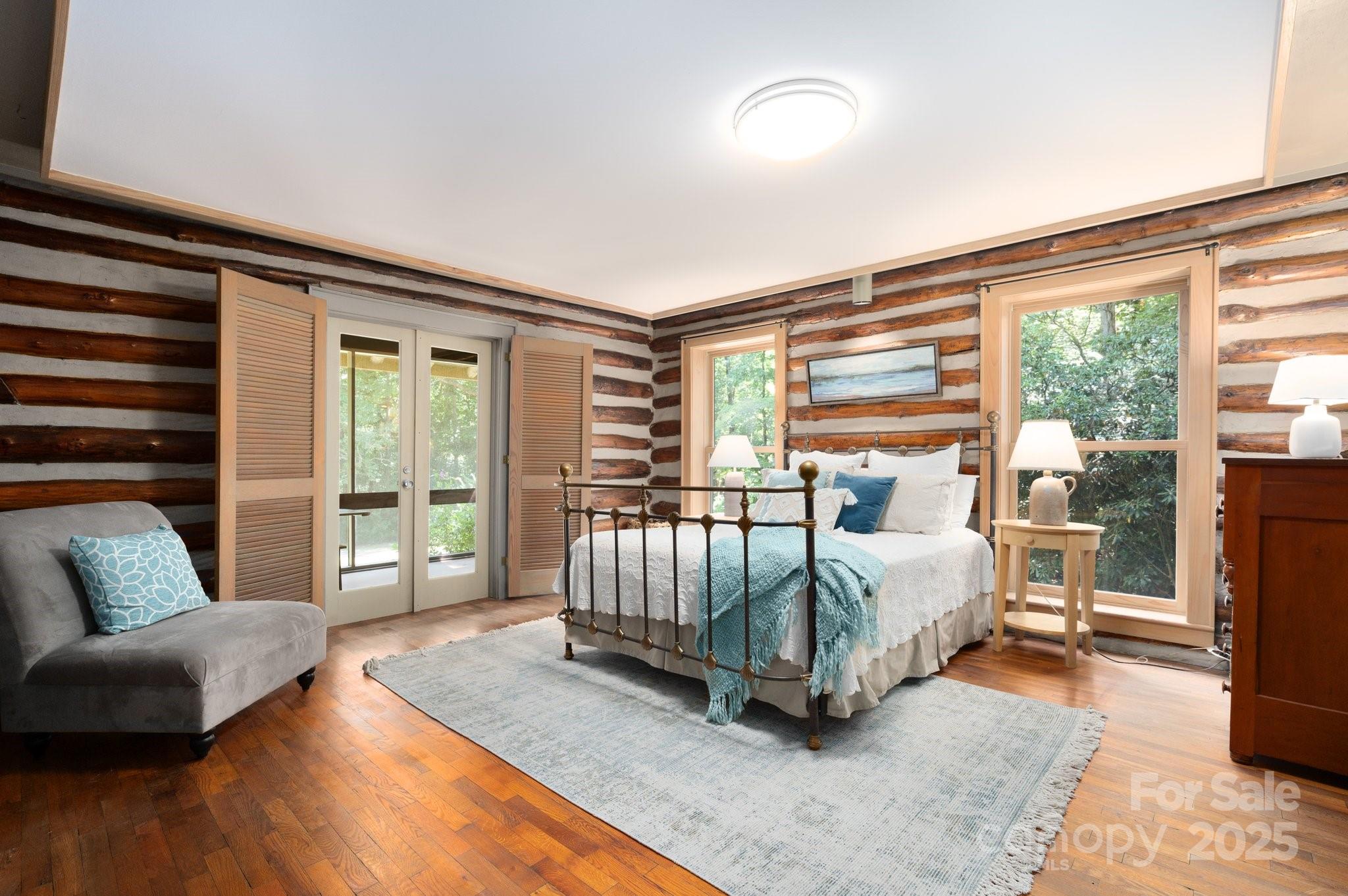 552 Averys Crk Road Arden, NC 28704 - Photo 21 of 48 a living room with a bed couch and a large window with outer view
