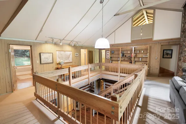 a living room with furniture a flat screen tv and a large window
