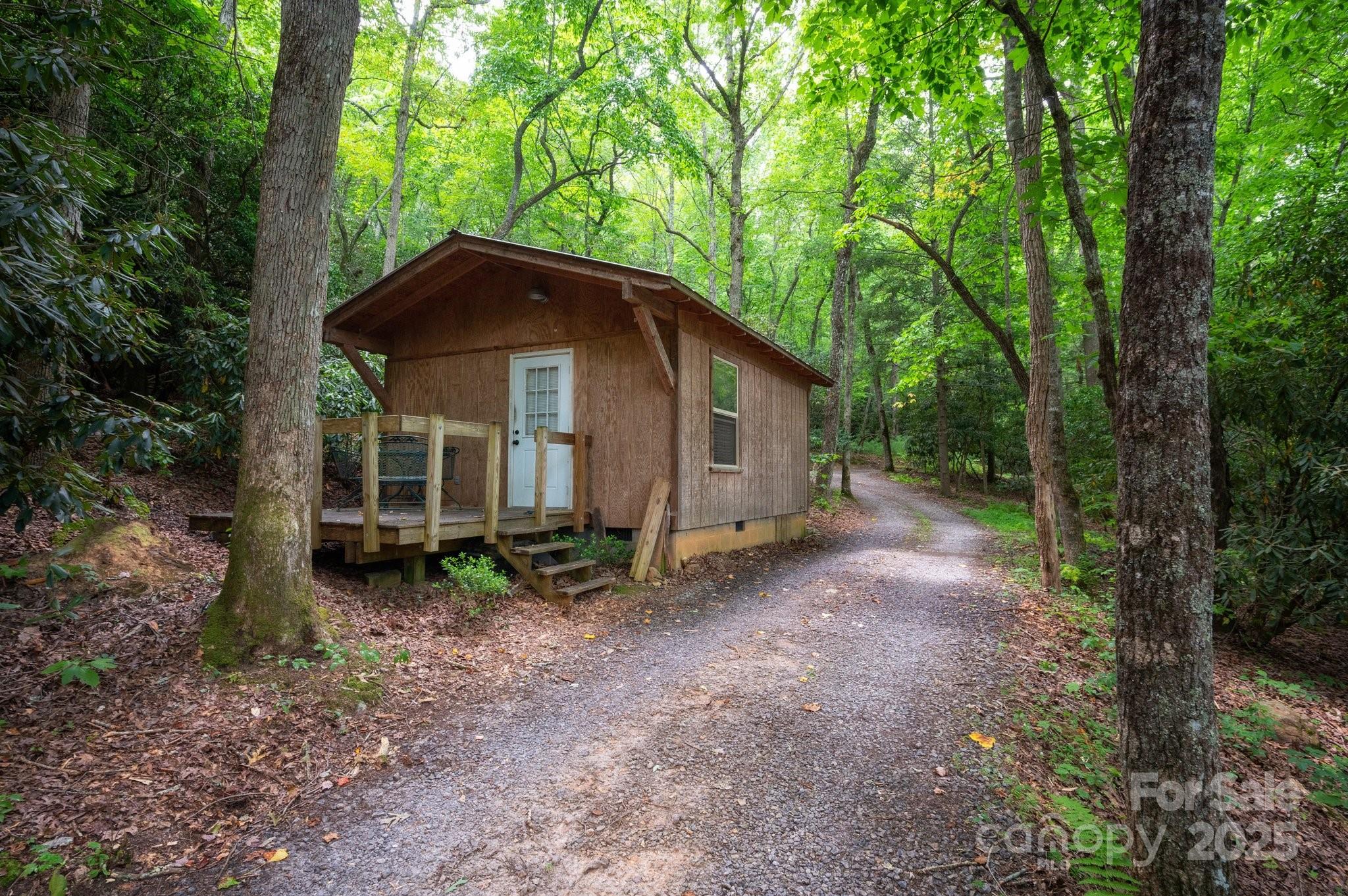 552 Averys Crk Road Arden, NC 28704 - Photo 39 of 48 a view of a house with large trees and a forest