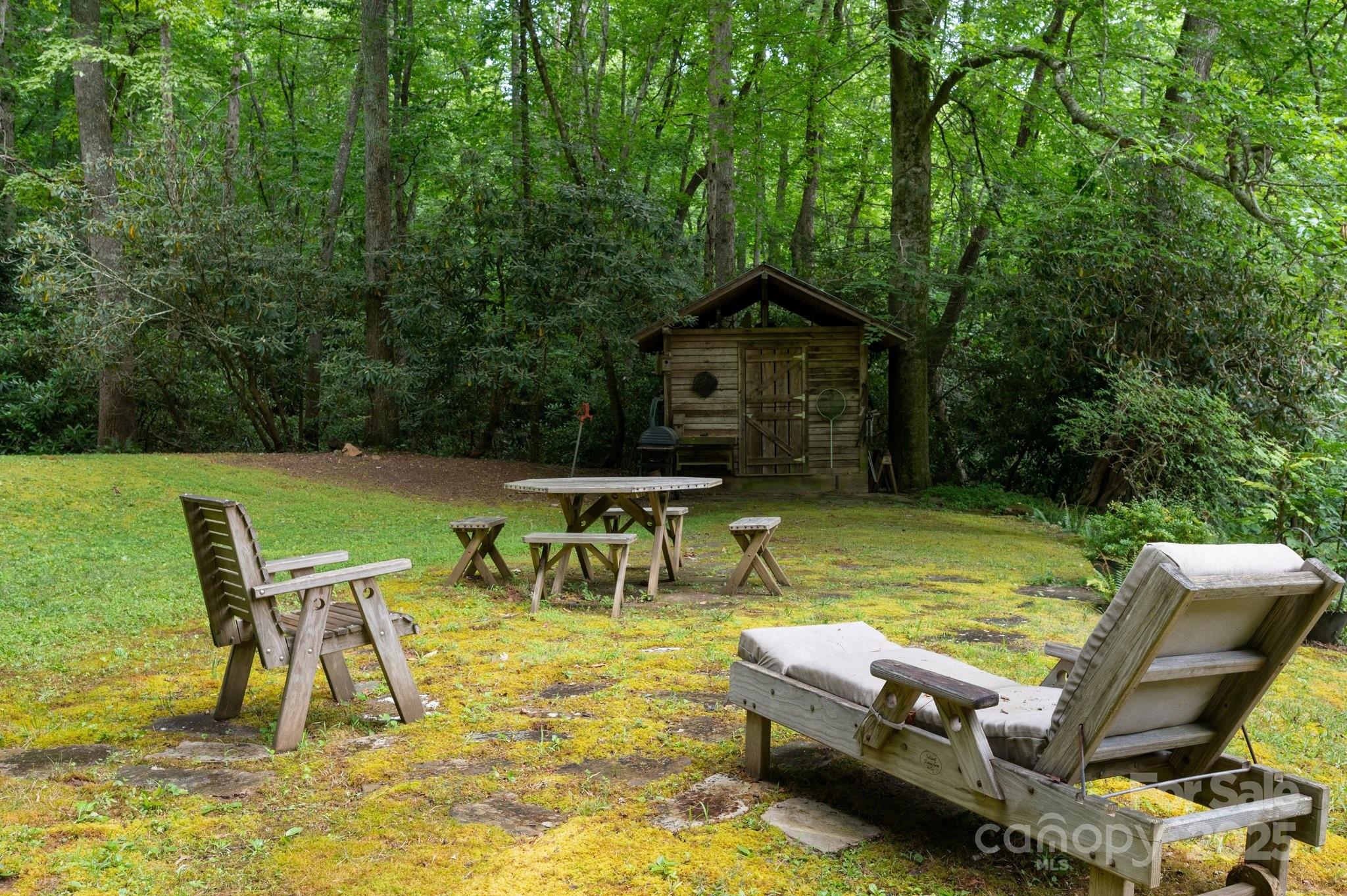 552 Averys Crk Road Arden, NC 28704 - Photo 46 of 48 a view of a swimming pool with lawn chairs under an umbrella