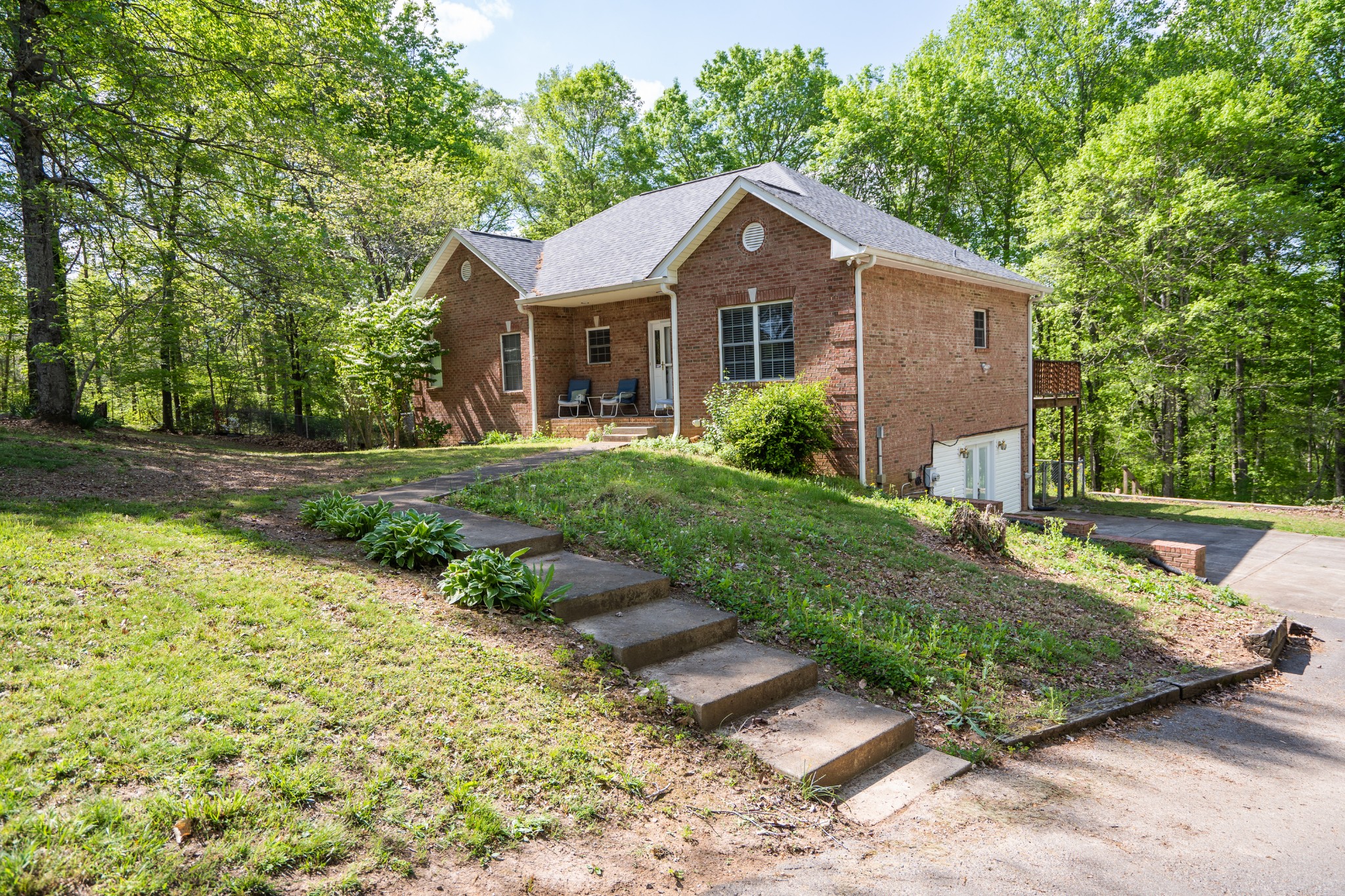 3077 Old Clarksville Sprgfld Road Adams, TN 37010 - Photo 1 of 33 a front view of a house with garden
