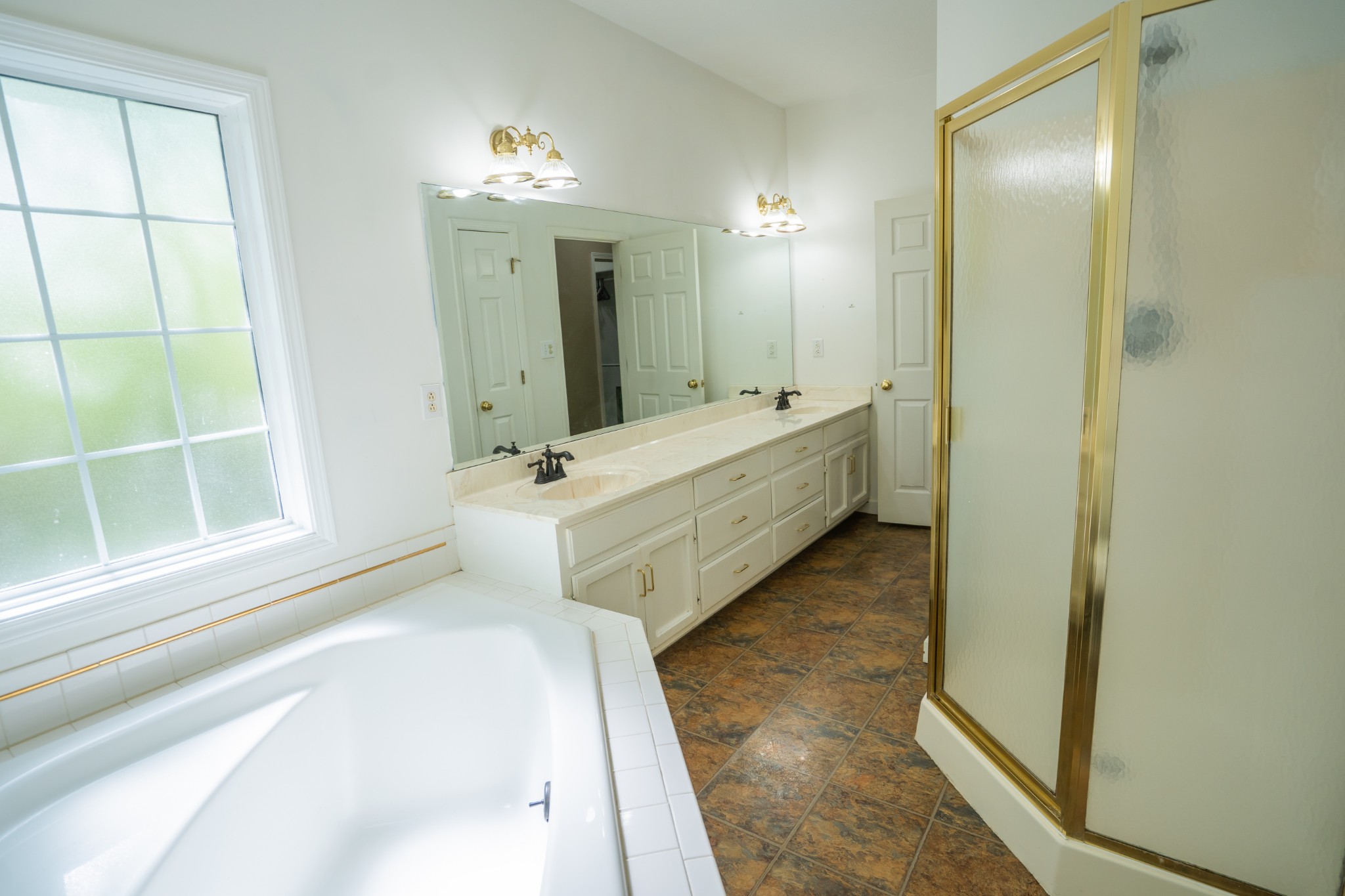 3077 Old Clarksville Sprgfld Road Adams, TN 37010 - Photo 16 of 33 a spacious bathroom with a bathtub sink and mirror